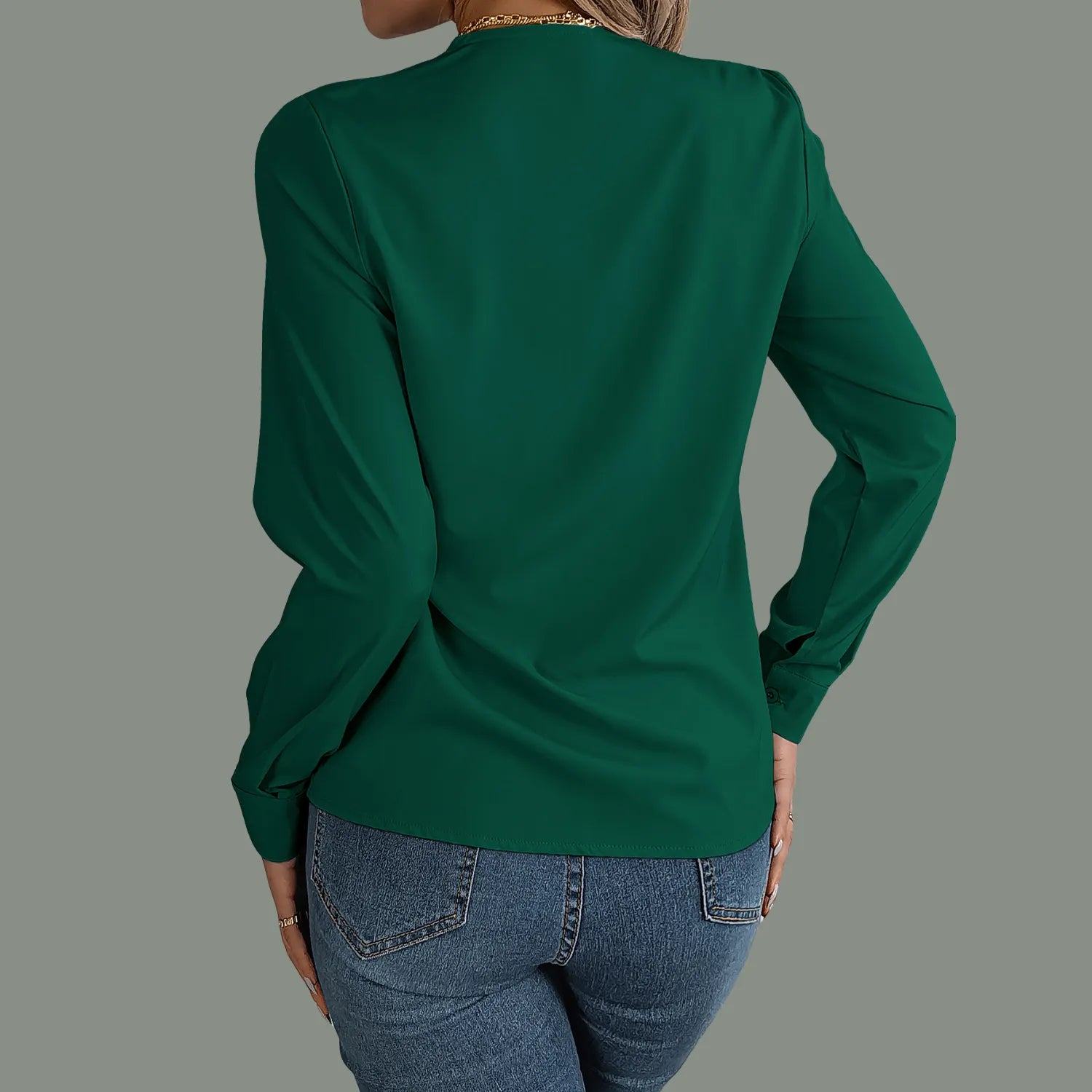 Elegant V-Neck Blouse from Baltere, featuring a stylish pleated neckline and long sleeves, showcasing a professional look in green.