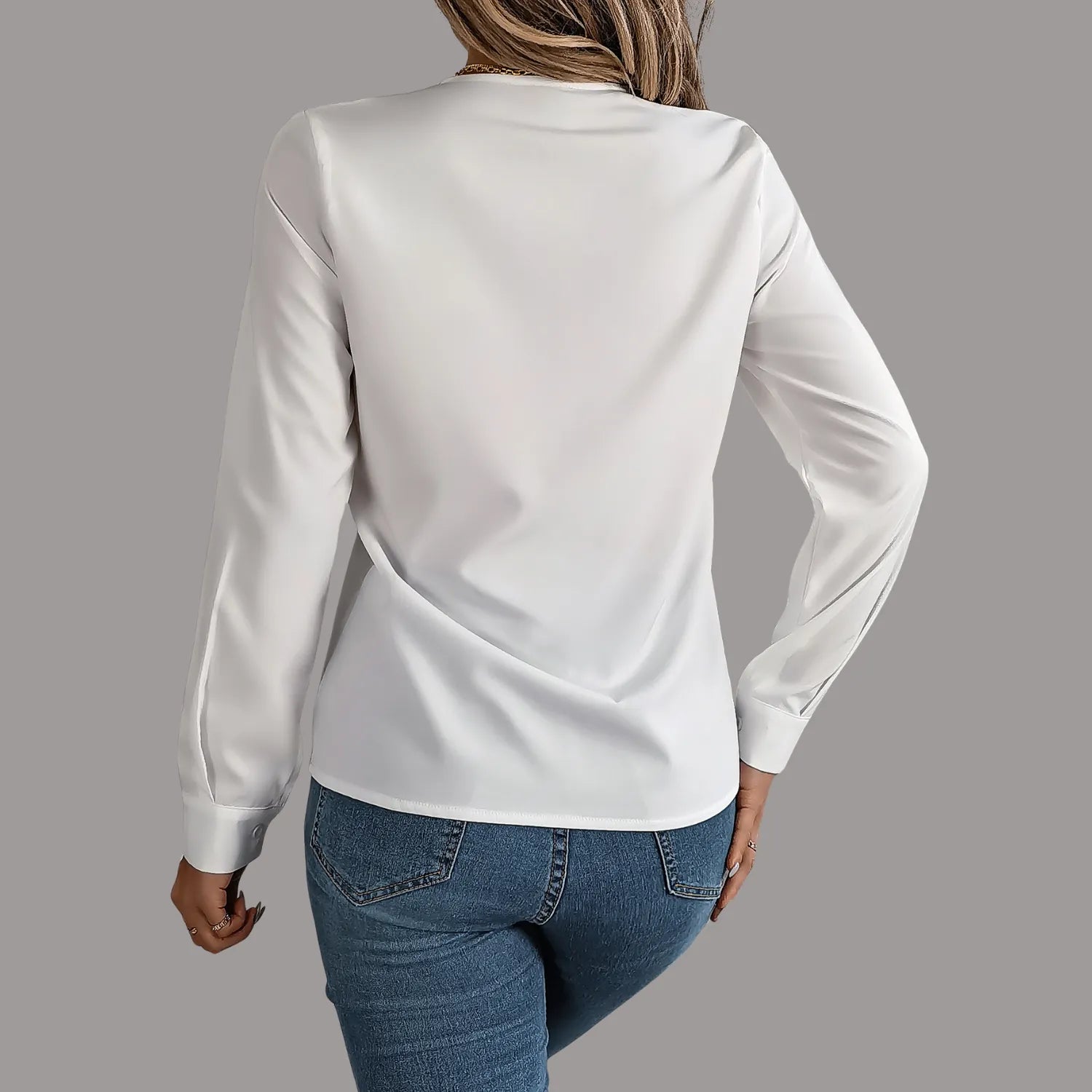 Elegant V-Neck Blouse, featuring a stylish pleated neckline and long sleeves, showcasing a professional look in white.