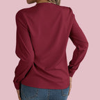 Elegant V-Neck Blouse from Baltere, featuring a stylish pleated neckline and long sleeves, showcasing a professional look.