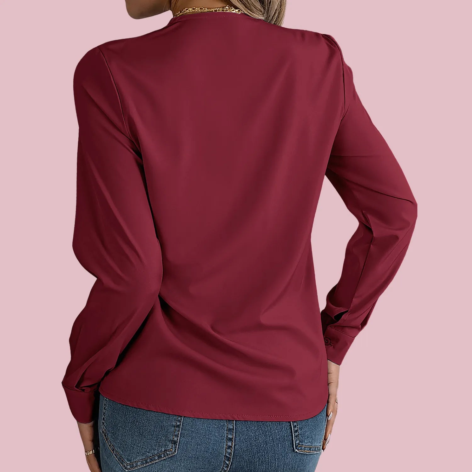 Elegant V-Neck Blouse from Baltere, featuring a stylish pleated neckline and long sleeves, showcasing a professional look.