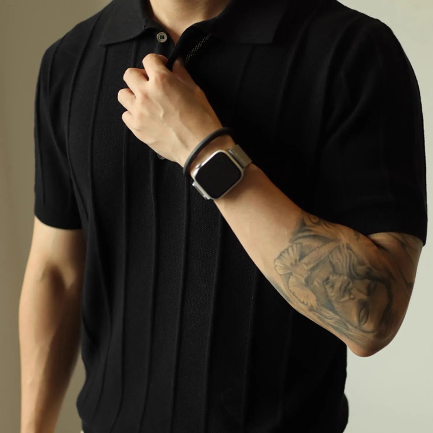 Model wearing Baltere's classic men's polo shirt, showcasing its relaxed fit and modern style in black.