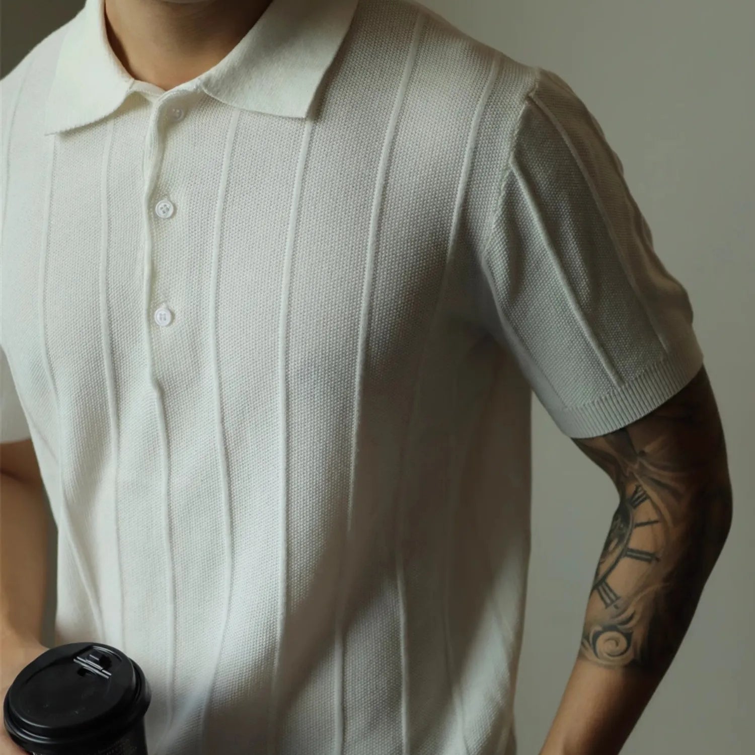 Model wearing Baltere's classic men's polo shirt, showcasing its relaxed fit and modern style in white.