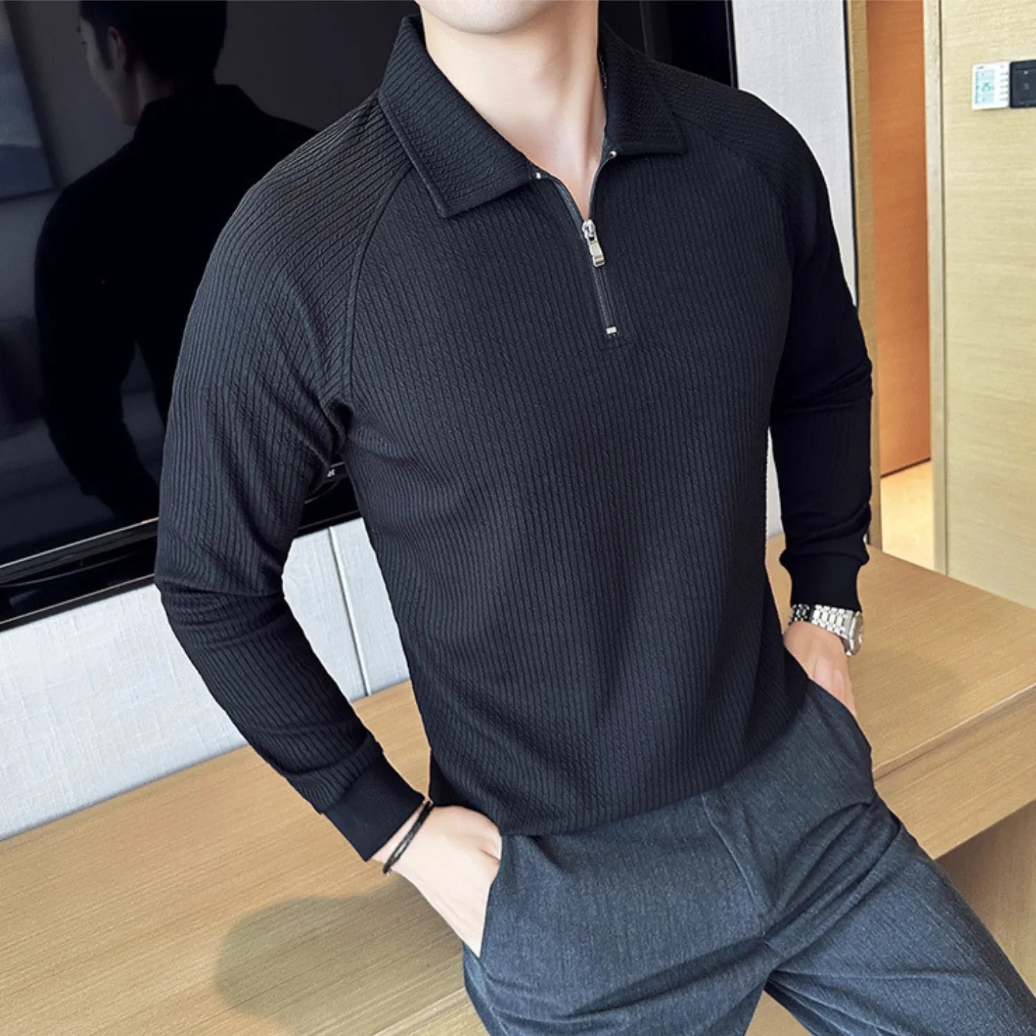 Model wearing Baltere's Half-Zip Polo Shirt, showcasing its unique textured fabric in black.