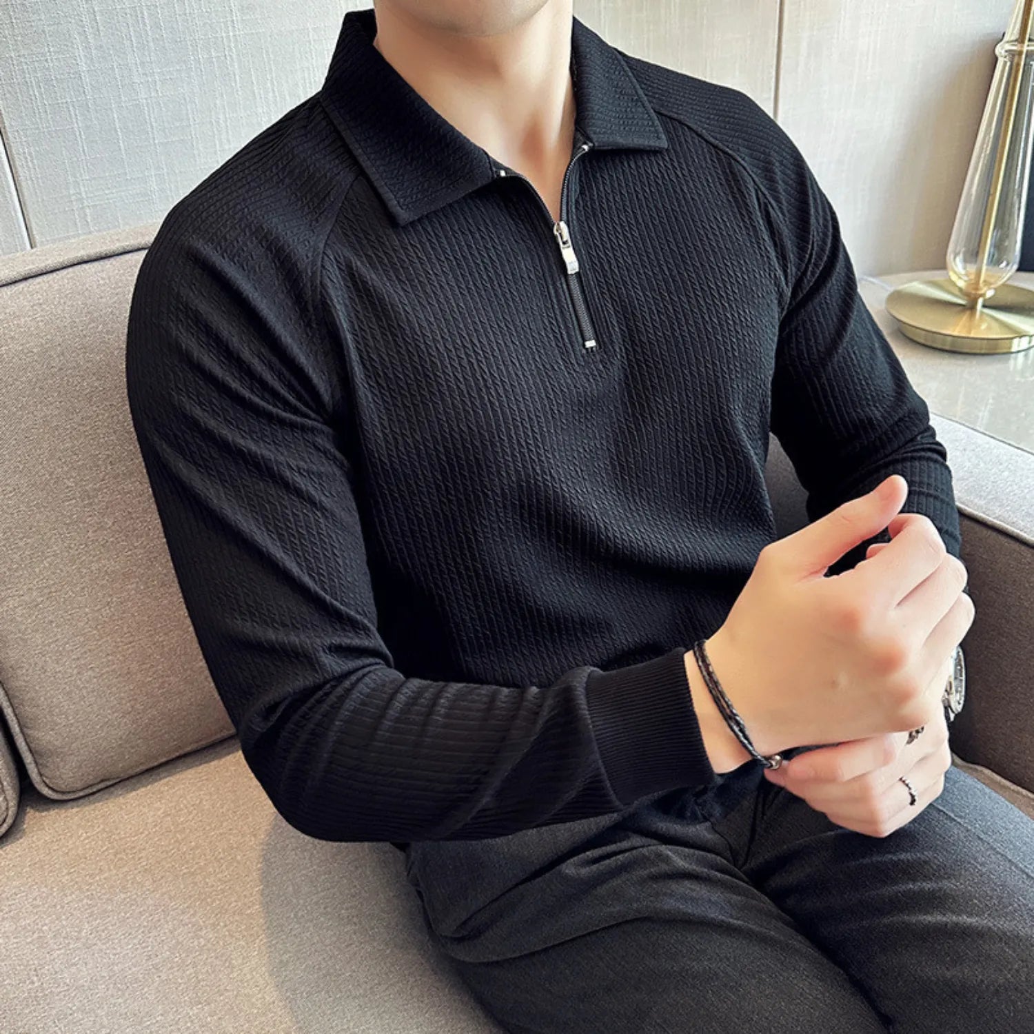 Model wearing Baltere's Half-Zip Polo Shirt black, and casual yet sophisticated style.