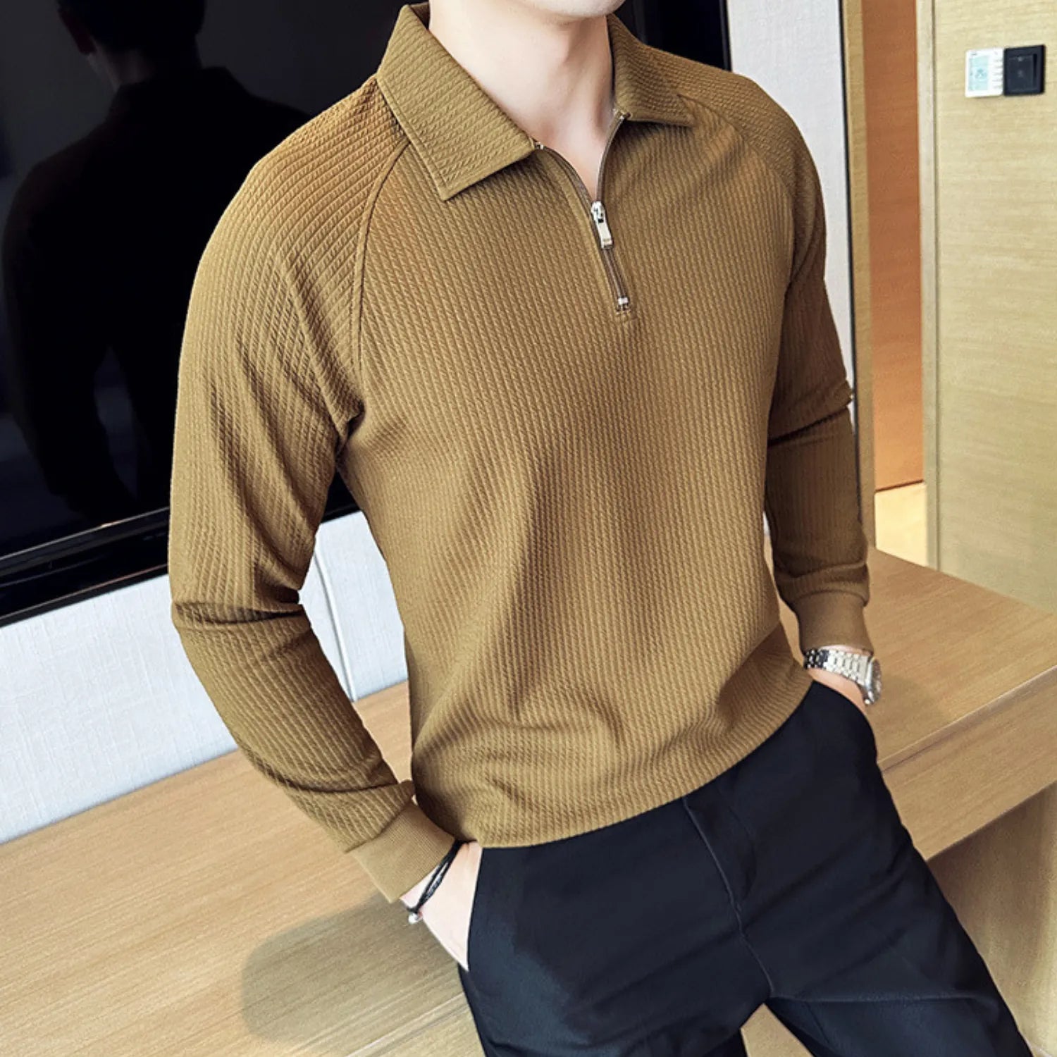 Model wearing Baltere's Half-Zip Polo Shirt, showcasing its unique textured fabric in kahki.