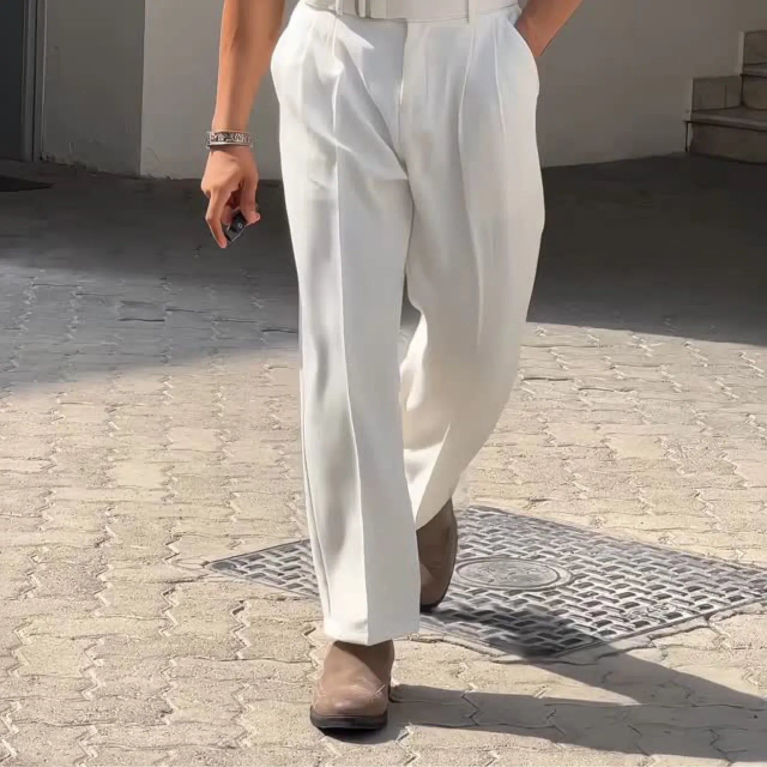 Detailed view of the Baltere Men's High-Waisted Pleated Trousers, highlighting the loose, flowing silhouette and classic pleat detail.