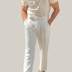 Model wearing Baltere's Men's High-Waisted Pleated Trousers, showcasing the elegant fit in white.