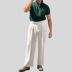 Model wearing Baltere's Men's High-Waisted Pleated Trousers white, showcasing the elegant fit and classic front pleats.