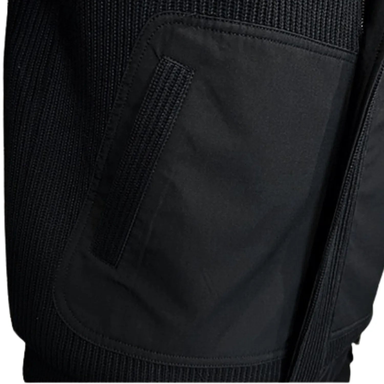 Close-up of the men's coat, showing the contrast between the smooth side pocket and the ribbed knitted texture.