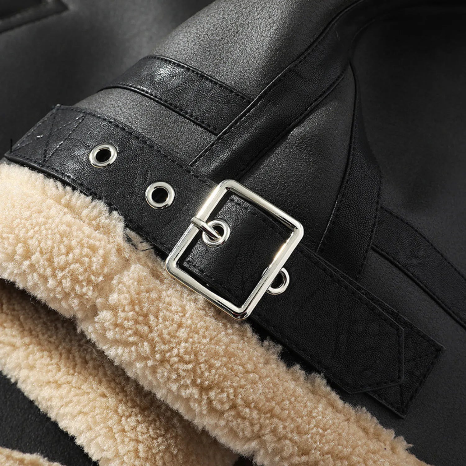 Close-up of the jacket's fist, highlighting the metal buckle and cozy fleece lining.