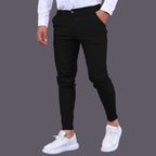 Model wearing Baltere's Men's Slim Fit Business Trousers, showcasing the modern tapered leg and versatile business-casual style in black.
