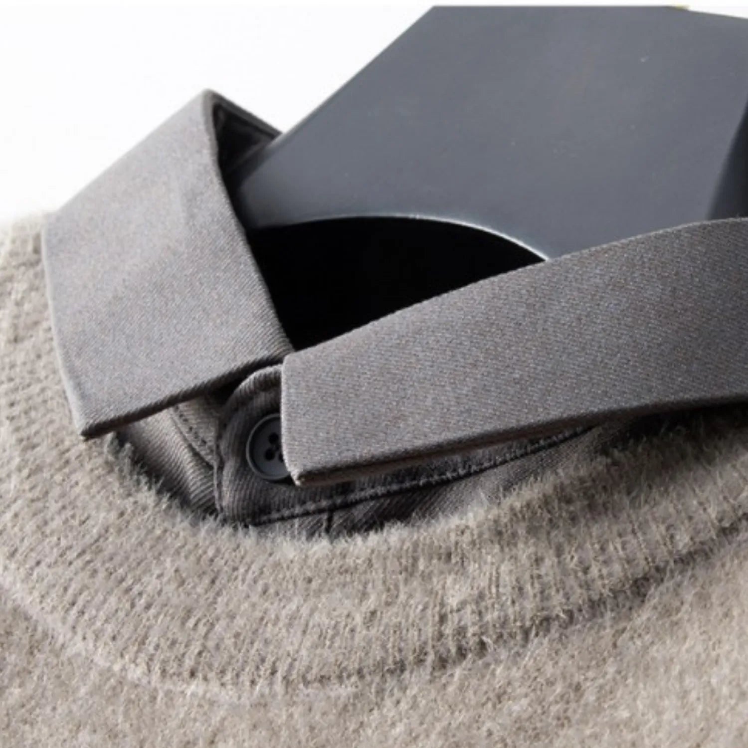 Detailed view of the Men's Two-Piece Look Sweater, showcasing the contrasting layered collar and knit fabric.