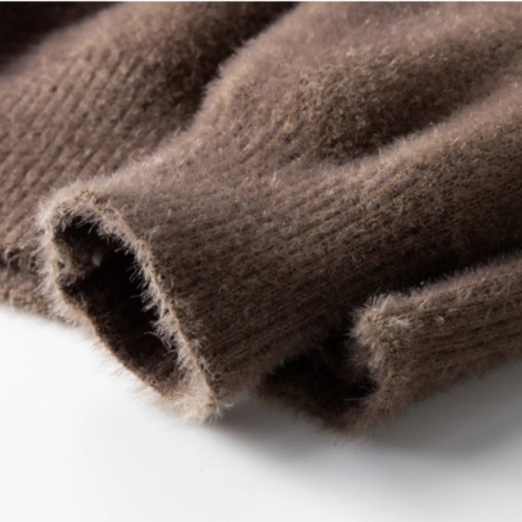 A detailed view of the men's sweater, showing the soft, plush texture of the knit fabric.