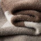 A detailed view of the Baltere Men's sweater, highlighting the diamond pattern and plush knit texture.