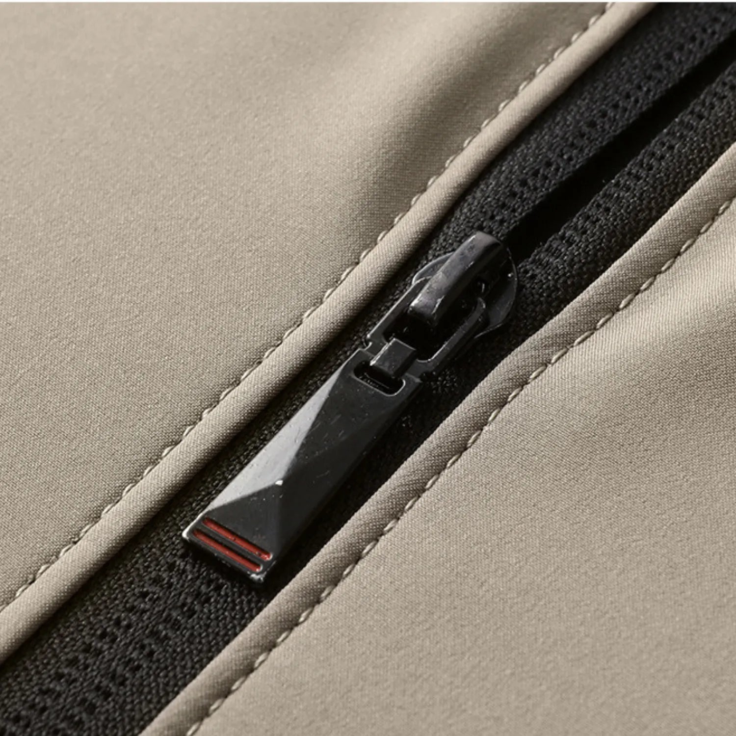 Close-up of the jacket's durable zipper, highlighting its quality hardware and sleek design.