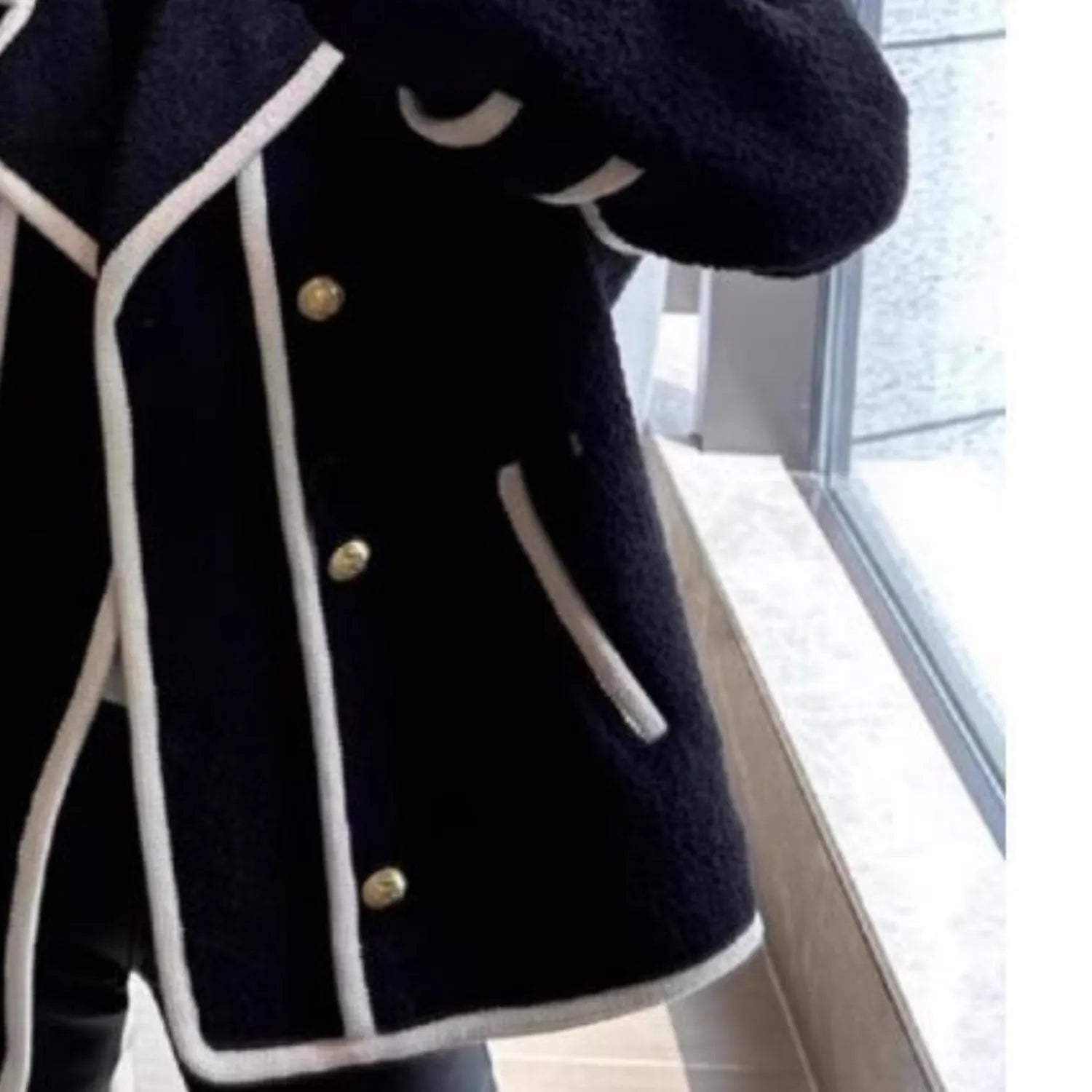 A detailed view of the Baltere Retro Fleece Top, showcasing its classic piping, gold buttons, and functional side pocket.