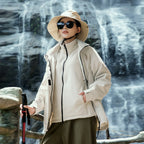Model wearing Baltere's Women's 3-in-1 Waterproof Jacket khaki, showcasing the hooded design, dual layer system, and outdoor performance features.