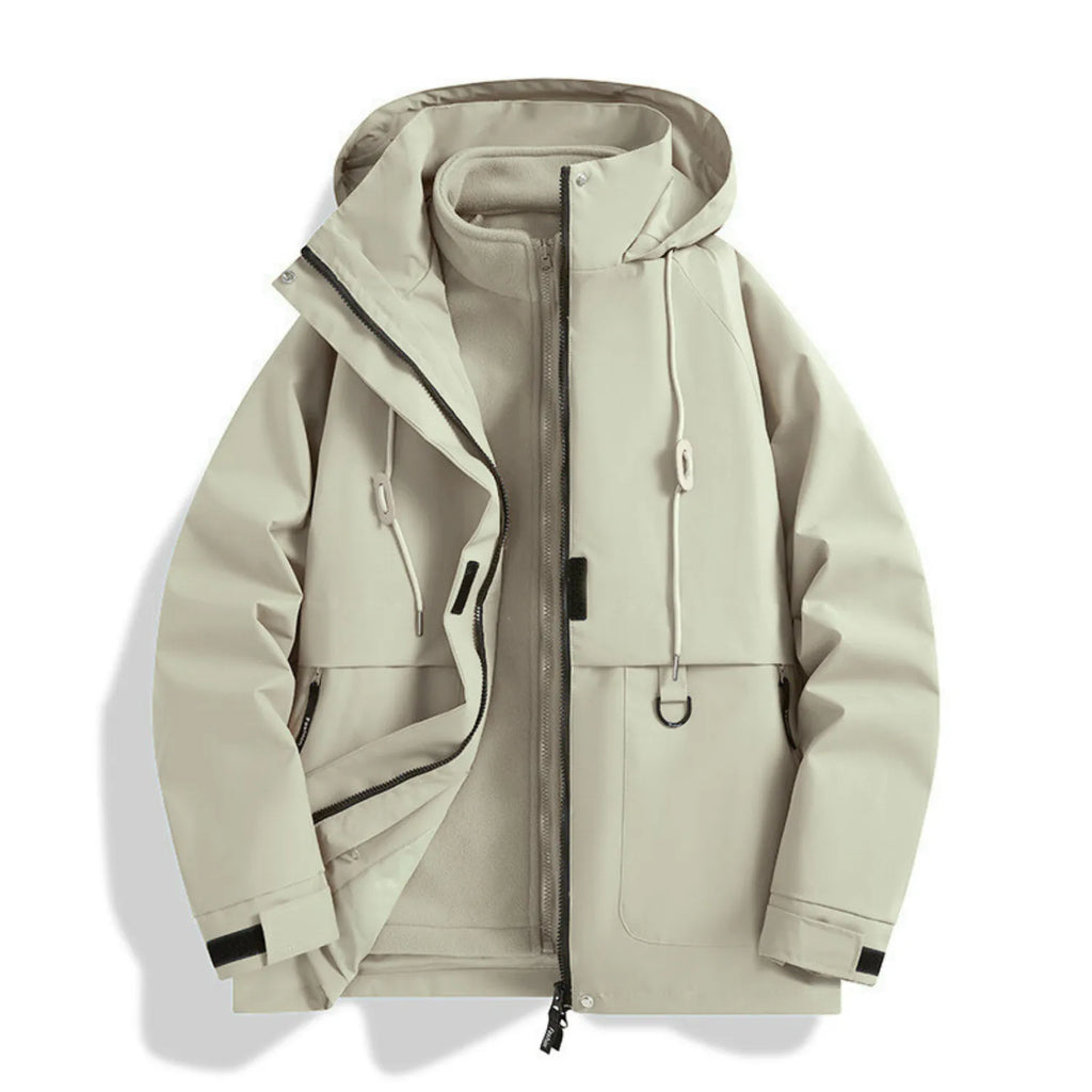 Model wearing Baltere's Women's 3-in-1 Waterproof Jacket, showcasing the hooded design, dual layer system, and outdoor performance features, in khaki.