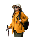 Model wearing Baltere's Women's 3-in-1 Waterproof Jacket yellow, made from durable polyester, showcasing the hooded design and dual-layer system.