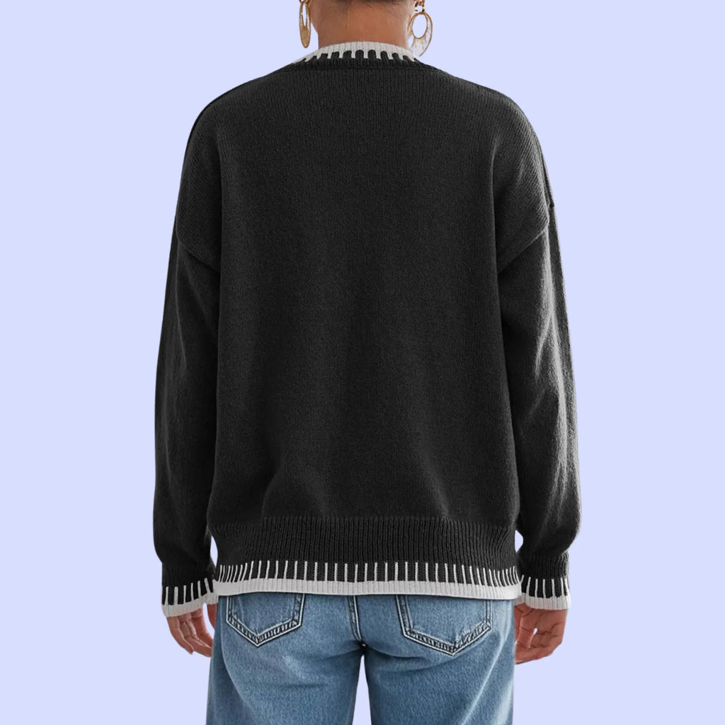 Rear view of Baltere's Contrast Color Pullover Sweater black, showcasing the relaxed fit, ribbed hem, and contrast trim details on the cuffs and bottom.