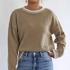 Model wearing the Women's Contrast Color Pullover Sweater, made from soft knitwear, emphasizing its comfortable fit and stylish detailing, in khaki.