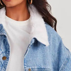 Detailed close-up of the Baltere women's denim jacket, showcasing the cozy sherpa collar and metal button accents.