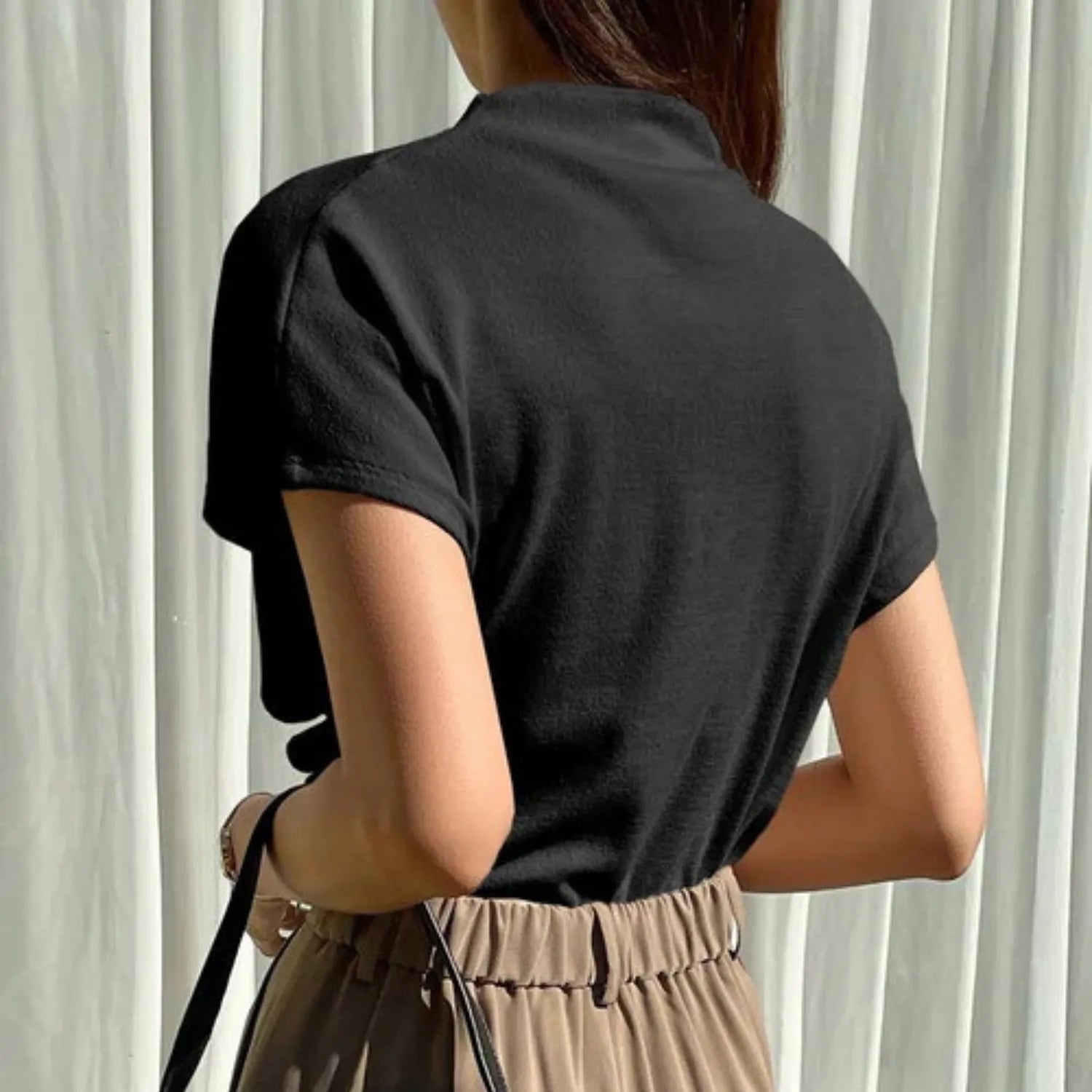 Rear view of the Women's Draping Pullover Top black, highlighting the sophisticated fabric drape and short sleeves.