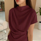 Model wearing the Baltere Draping Top, showcasing the flattering silhouette and seamless back design, in wine.