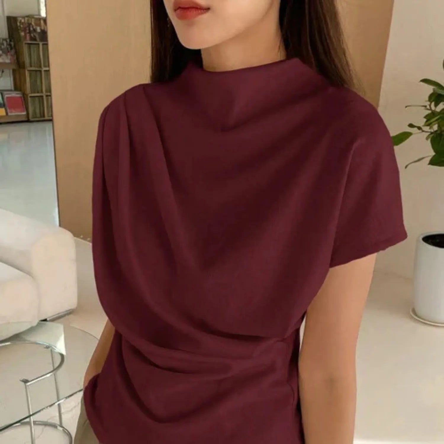 Model wearing the Baltere Draping Top, showcasing the flattering silhouette and seamless back design, in wine.