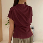 Model wearing the Baltere Draping Top wine, showcasing the flattering silhouette.