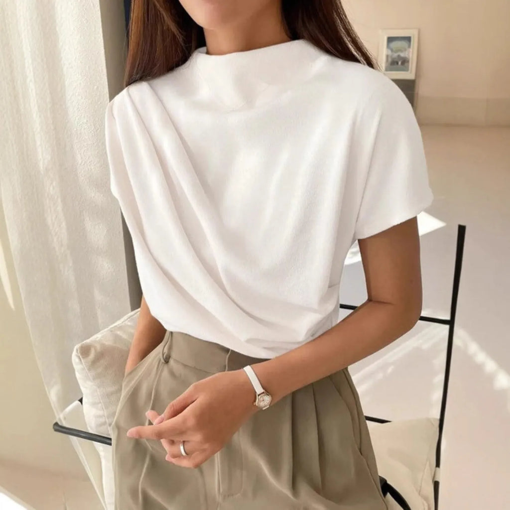 Model wearing the Baltere Draping Top white, showcasing the flattering silhouette.