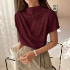 Model wearing Baltere's Draping Short Sleeve Pullover Top wine, showcasing the elegant cowl neckline and relaxed fit.