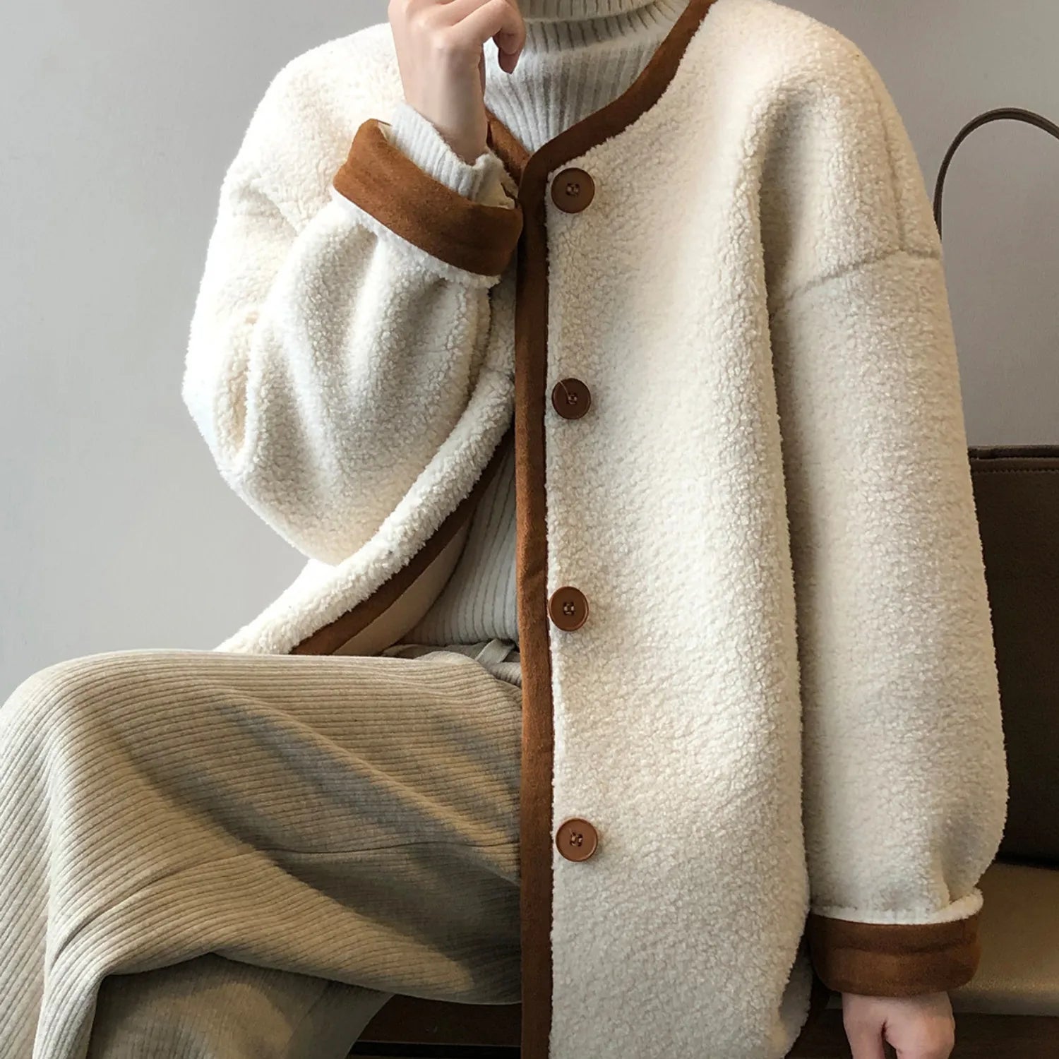 Detailed view of the women's East Asian Inspired Sherpa Coat, front buttons, and cozy faux fur texture.