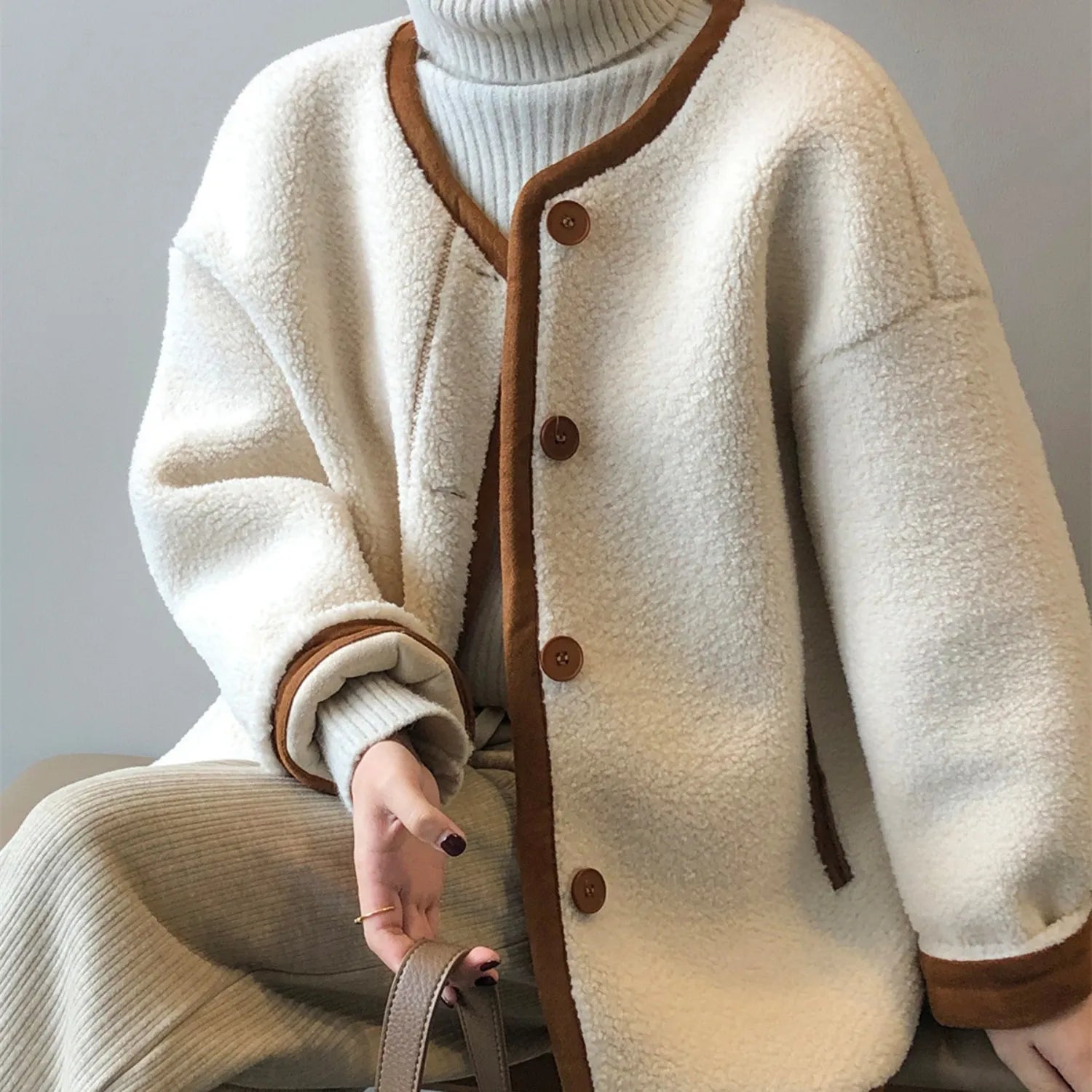 Baltere Women's East Asian Inspired Sherpa Coat, featuring a cozy faux fur texture, in of white, round buttons, and contrasting trim.