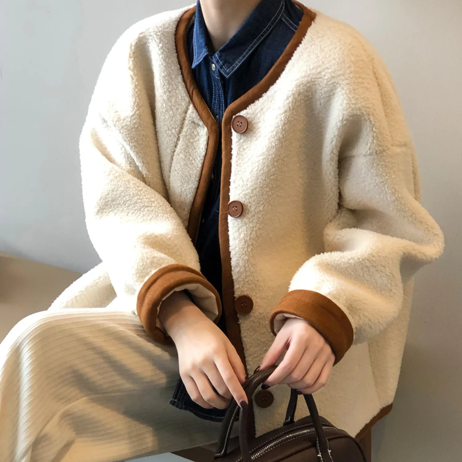 Women's East Asian Inspired Sherpa Coat, featuring a cozy faux fur texture, round buttons, and contrasting trim.