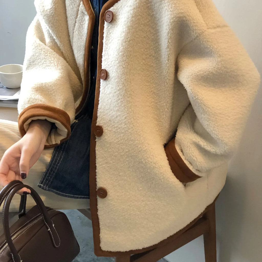 Detailed view of the women's East Asian Inspired Sherpa Coat, highlighting the contrasting trim, front buttons, and cozy faux fur texture.