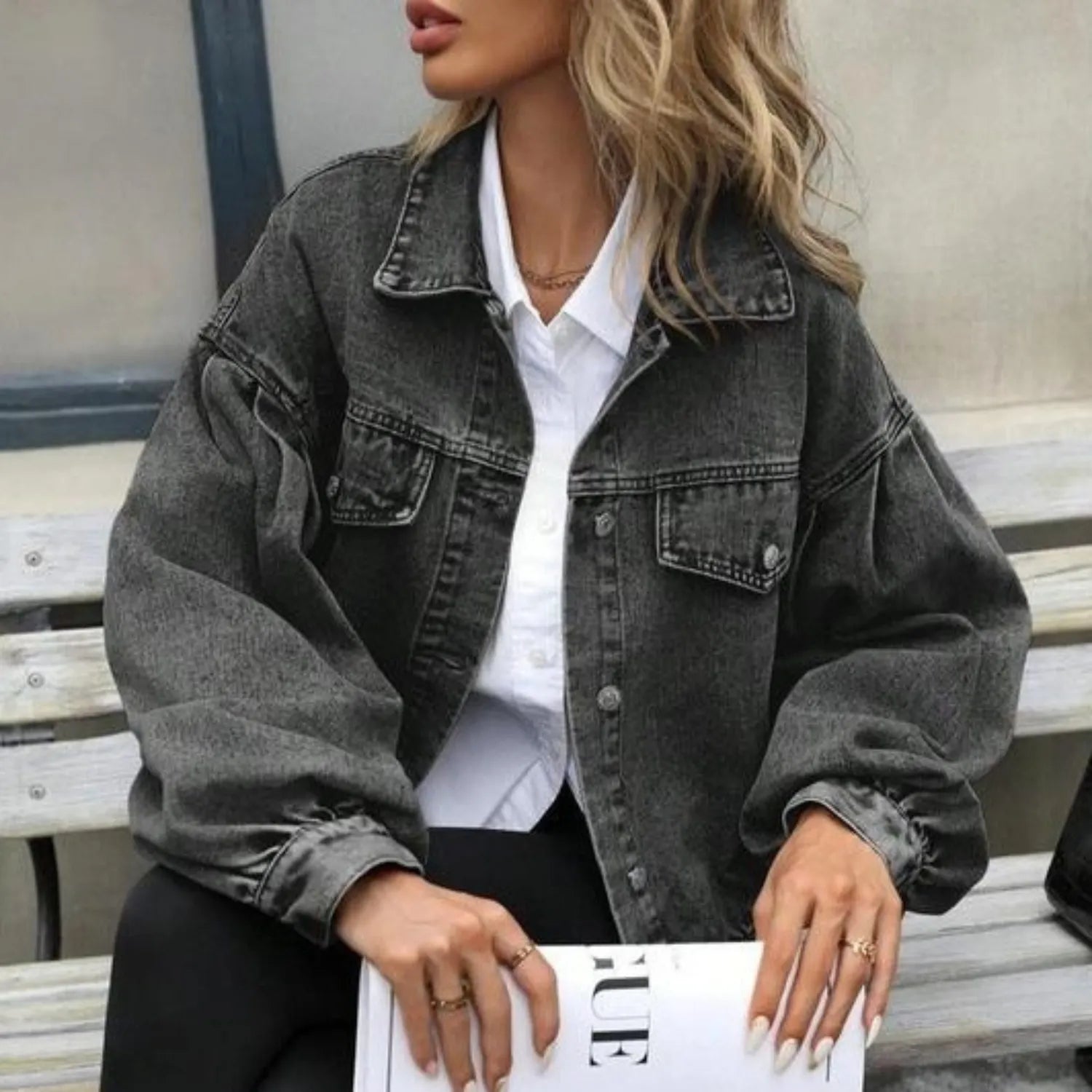Model wearing Baltere's Women's Embossed Denim Jacket dark gray, showcasing its slim fit, button-up front, and casual style.