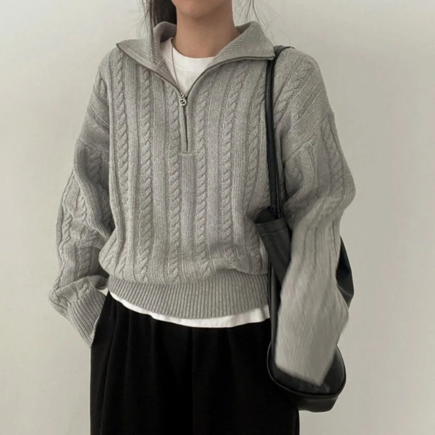 Model wearing Baltere's Women's High-Collar Zipper Pullover Top, showcasing its modern high-collar design.