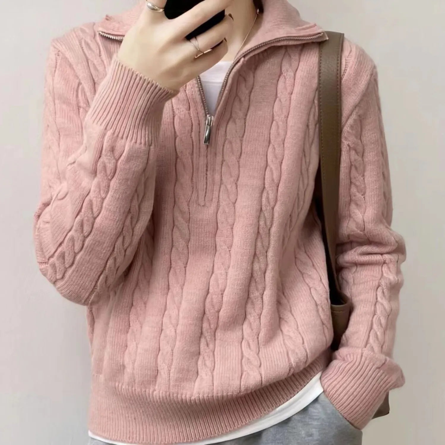 Model wearing Baltere's Women's High-Collar Zipper Pullover Top, showcasing its modern high-collar design and quarter-zip feature in pink.