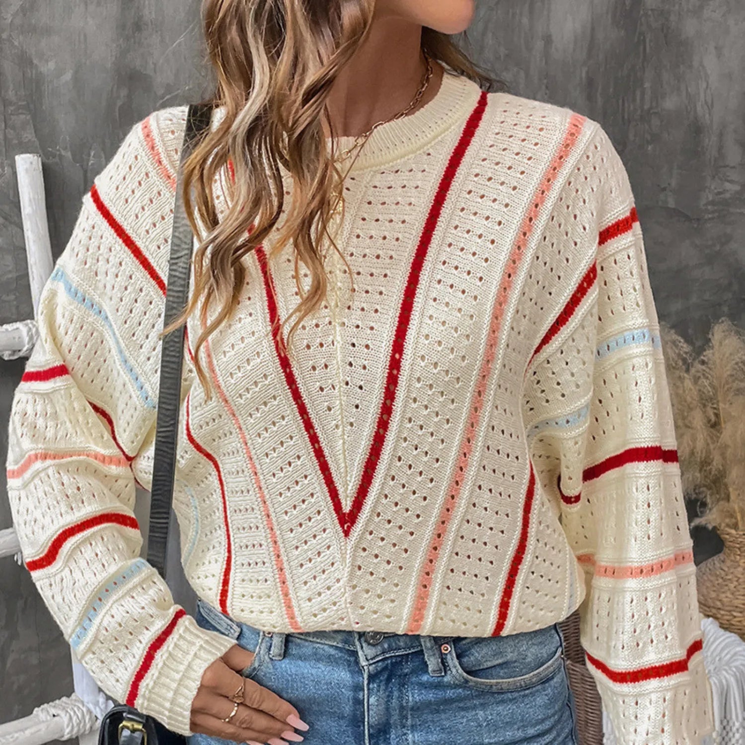 Model wearing Baltere's Hollow Out Sweater, featuring a V-stripe pattern, beige and a relaxed fit.