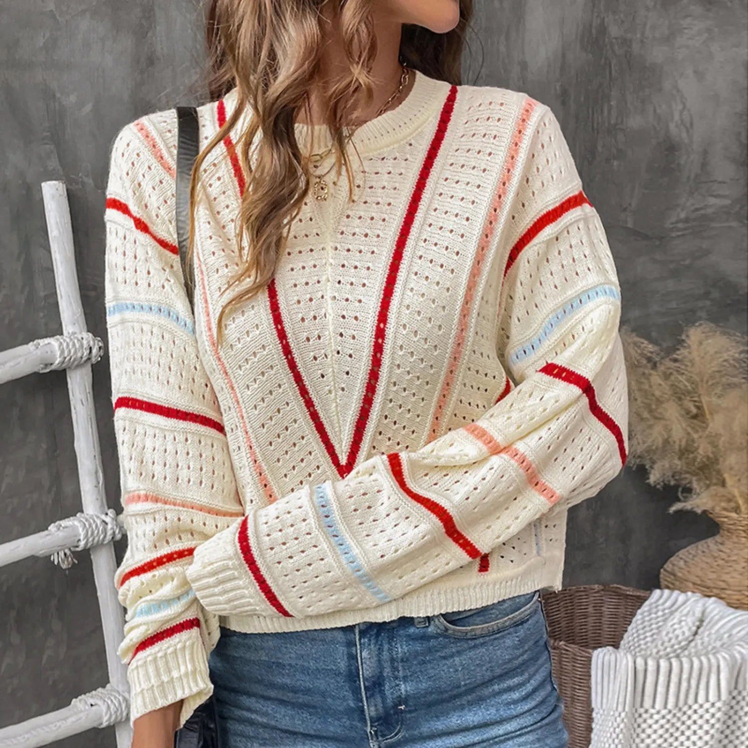 Model wearing Baltere's Hollow Out Sweater, modern, featuring a V-stripe pattern and a relaxed fit.