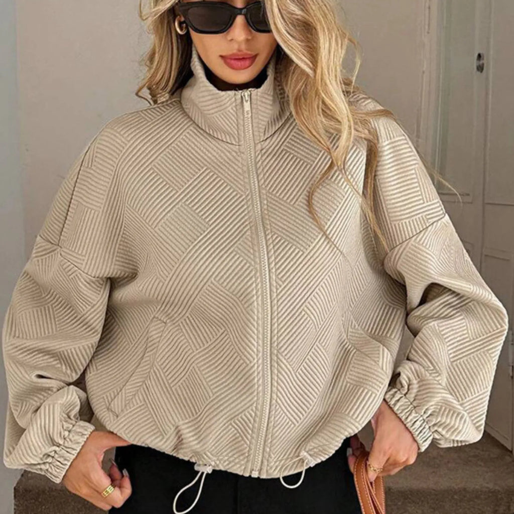 Model wearing Baltere's Loose Baseball Uniform Coat khaki, showcasing the textured fabric, high collar.