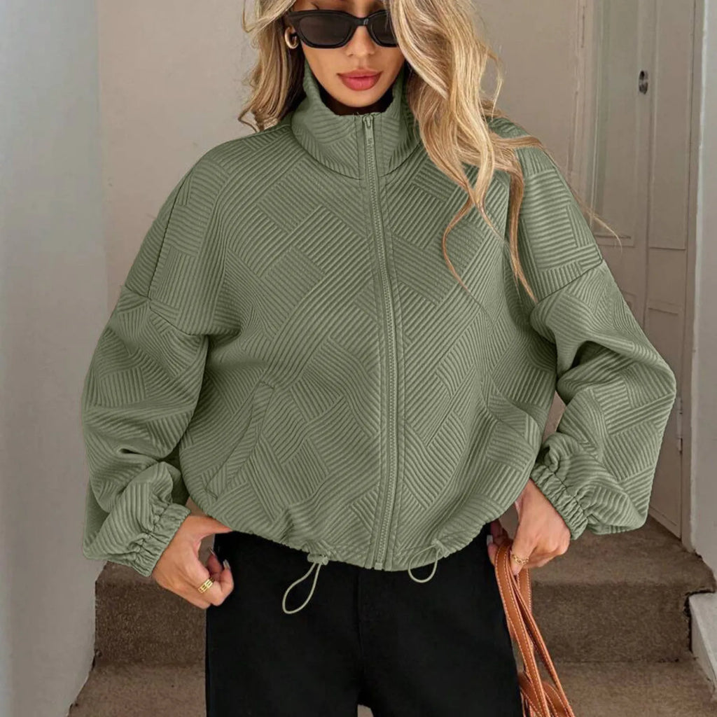 Model wearing Baltere's Loose Baseball Uniform Coat, showcasing the textured fabric, high collar, and comfortable casual style, in army green.