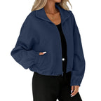Model wearing the Baltere Baseball Uniform Coat navy blue, highlighting its casual street style, cropped length, and zippered pockets.