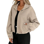 Model wearing Baltere's Loose Baseball Uniform Coat, showcasing the textured fabric, full-zip front, and comfortable, relaxed fit, in khaki.