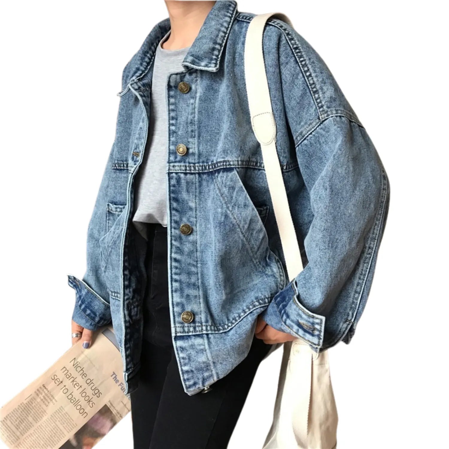 Model wearing Baltere's Retro Denim Jacket, showcasing its oversized fit, button-up front, and classic flap pockets.