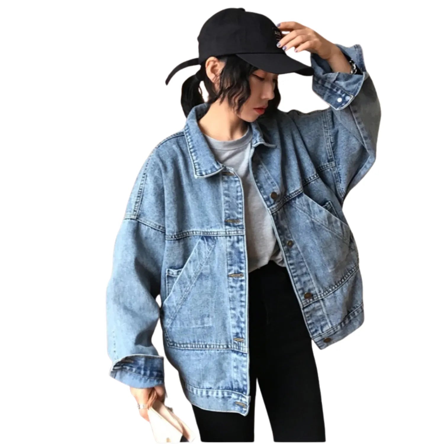 Model wearing Baltere's Retro Denim Jacket, showcasing its oversized fit, button-up front, and classic flap pockets in blue.