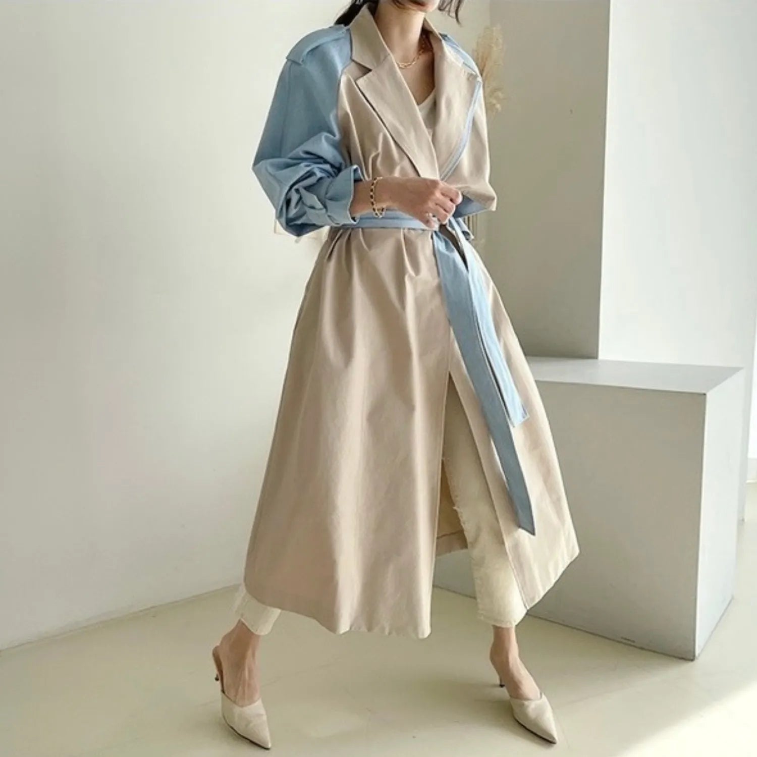 Model wearing Baltere's Retro Lapel Trench Coat, showcasing its dramatic two-tone design and belted waist.