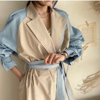 Model wearing the Baltere Trench Coat beige, emphasizing the oversized lapel and elegant, cinched-waist fit.