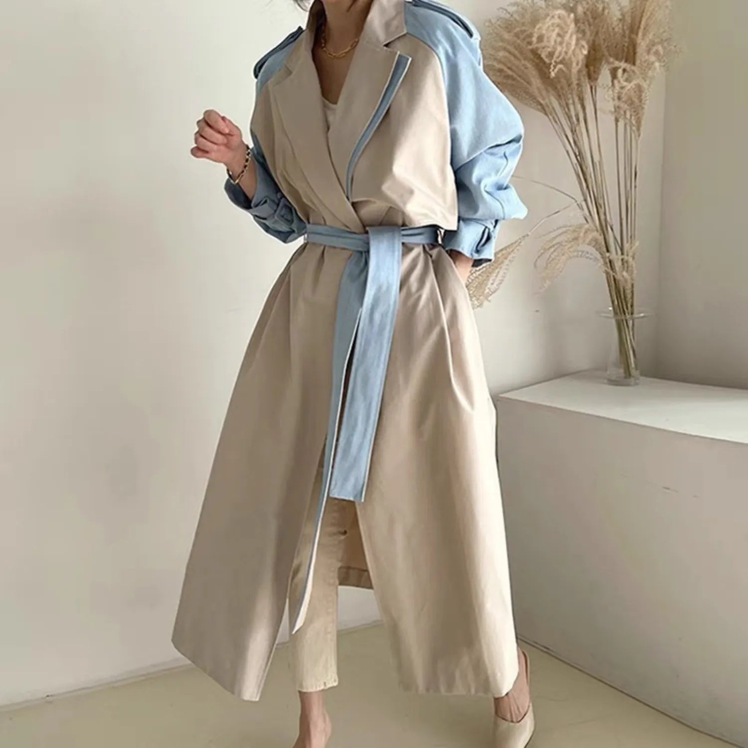Model wearing the Baltere Trench Coat beige, emphasizing the oversized lapel and elegant, cinched-waist fit.